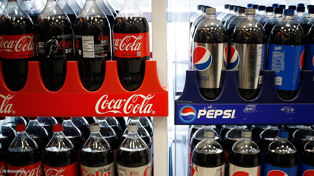Crates of various Coke and Pepsi products in bottles in cling wrap