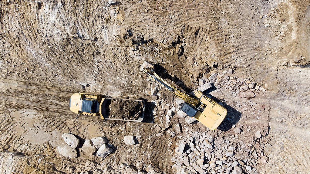 Earthmoving equipment moving ground during mine site construction.