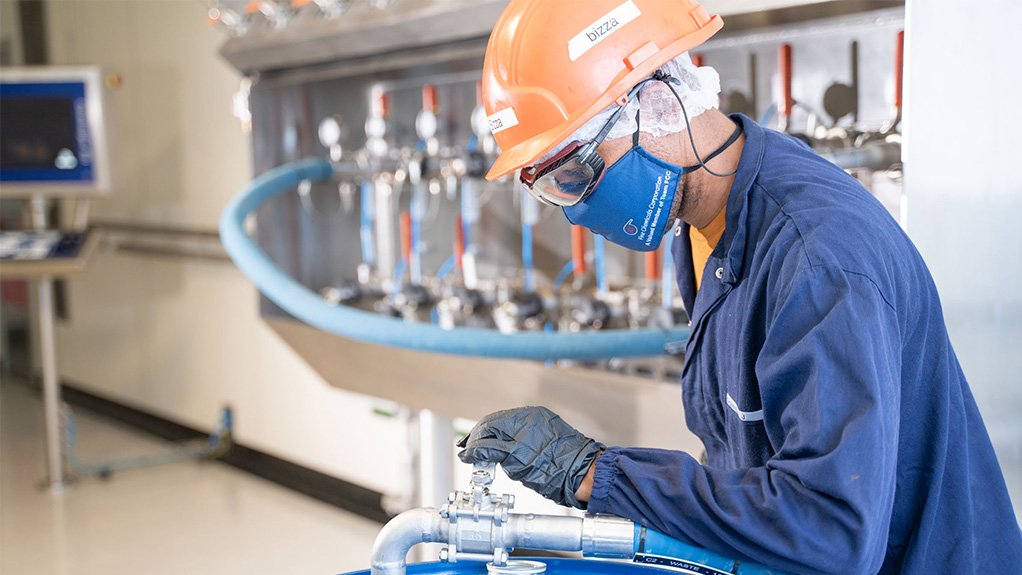 An image of a pharmaceutical developer working on a chemical