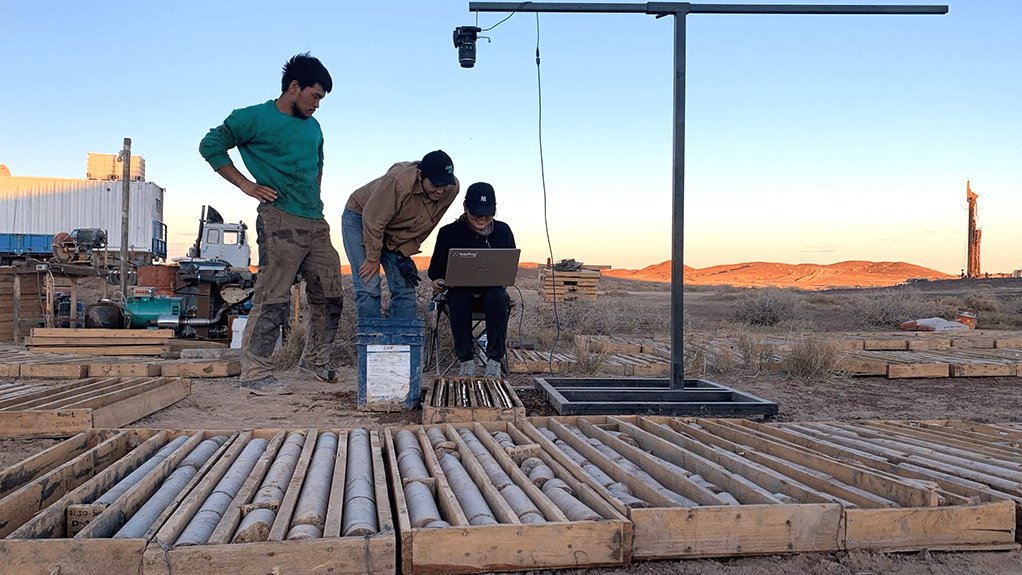 Image of person working on computer outside at a work site