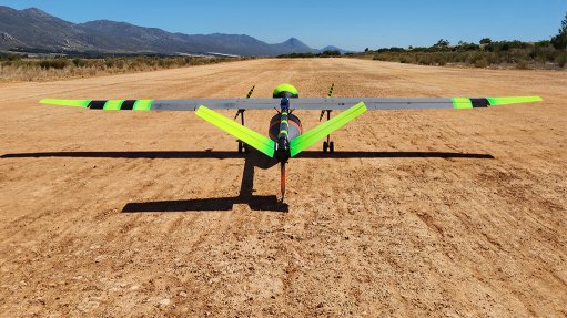 Drone on dirt runway readying to take off for test flight.