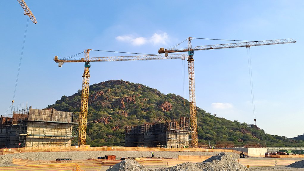 A construction site out in the bush with koppies in the background, where the refrigeration plant and fan station at Northam Platinum’s Zondereinde No 3 Shaft project in the western limb of the Bushveld Complex is being construvted