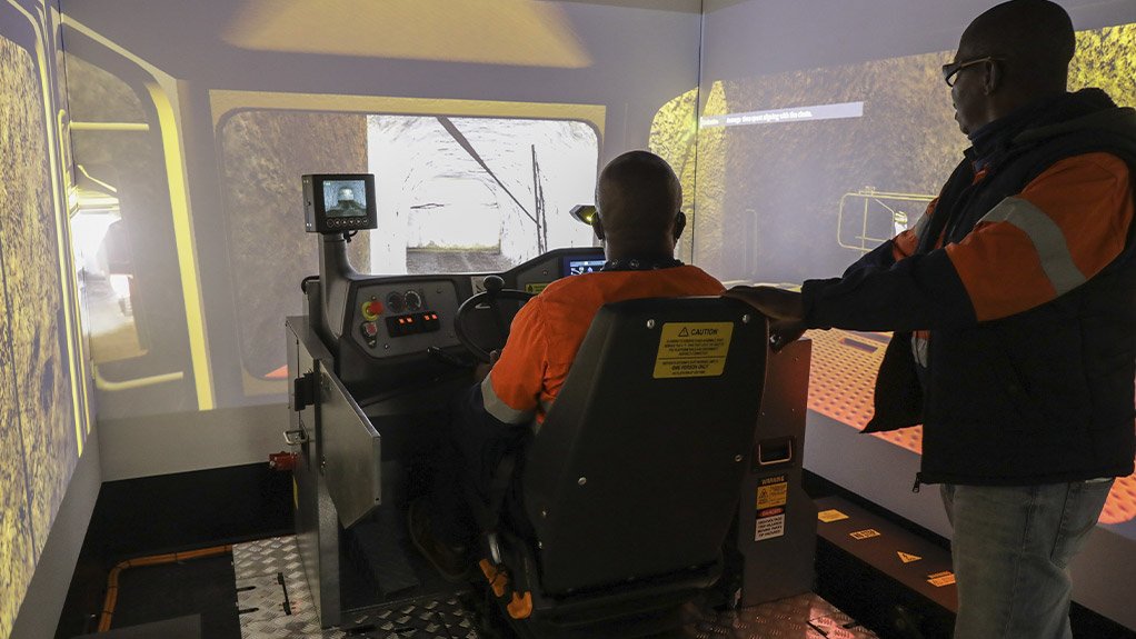 A training instructor at the Venetia mine instructing an employee in the simulator