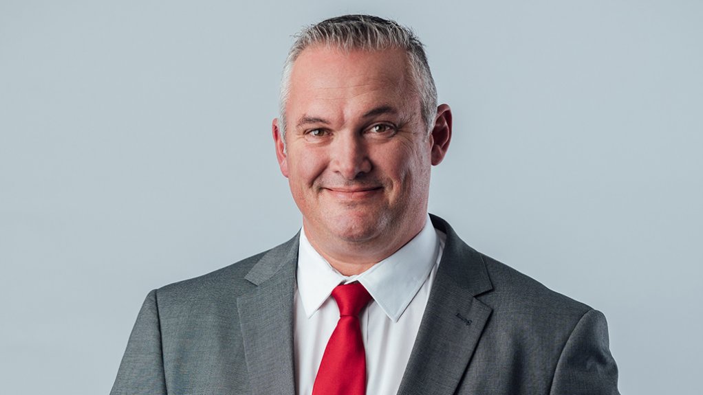 Jason Jackson in suit with red tie