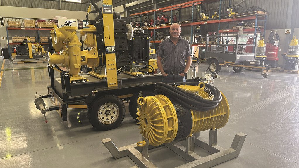 Lee Vine, Managing Director of IPR, standing next to an Atlas Copco diesel driven pump set and a submersible pump