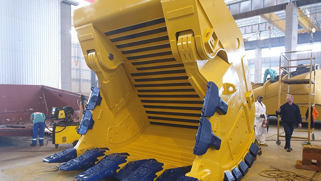 A yellow loader bucket on the shop floor.