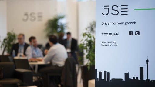 An image of the JSE logo with an ot of focus background of people meeting at an event