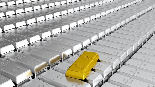 A sheet of platinum bullion bars with one solitary gold bar on top