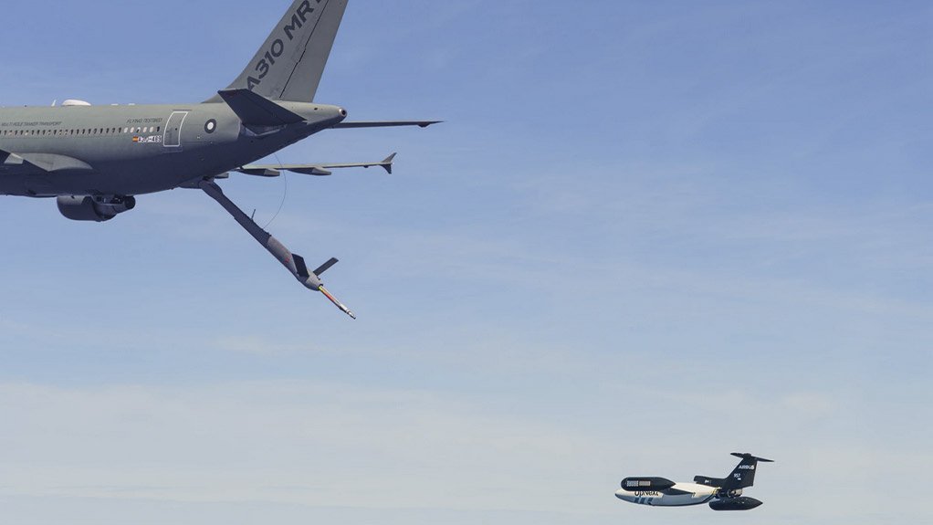 Two aircrafts close to one another preparing to refuel