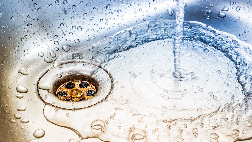 Image of water running down a sink