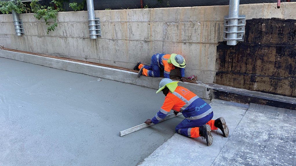 Concor finishing off concrete screed making sure it is floated to the correct level, ensuring that the surface and interface between new and old concrete is finished in the correct manner to allow following trades to continue without any rework