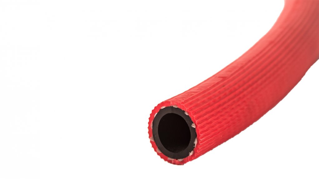 a single red fire hose suspended in the air