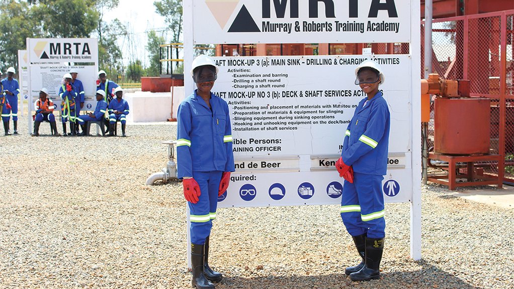 Image of two young women in overalls to illustrate Murray & Roberts Cementation Training Academy conducts cadet training programmes for mines