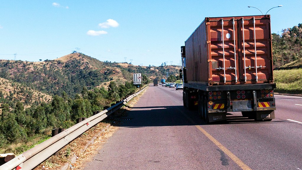 A truck transporting a container by road