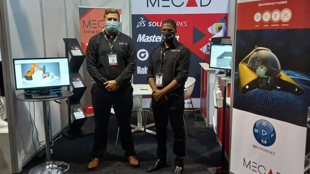 Two mask-wearing men at the MECAD stand 