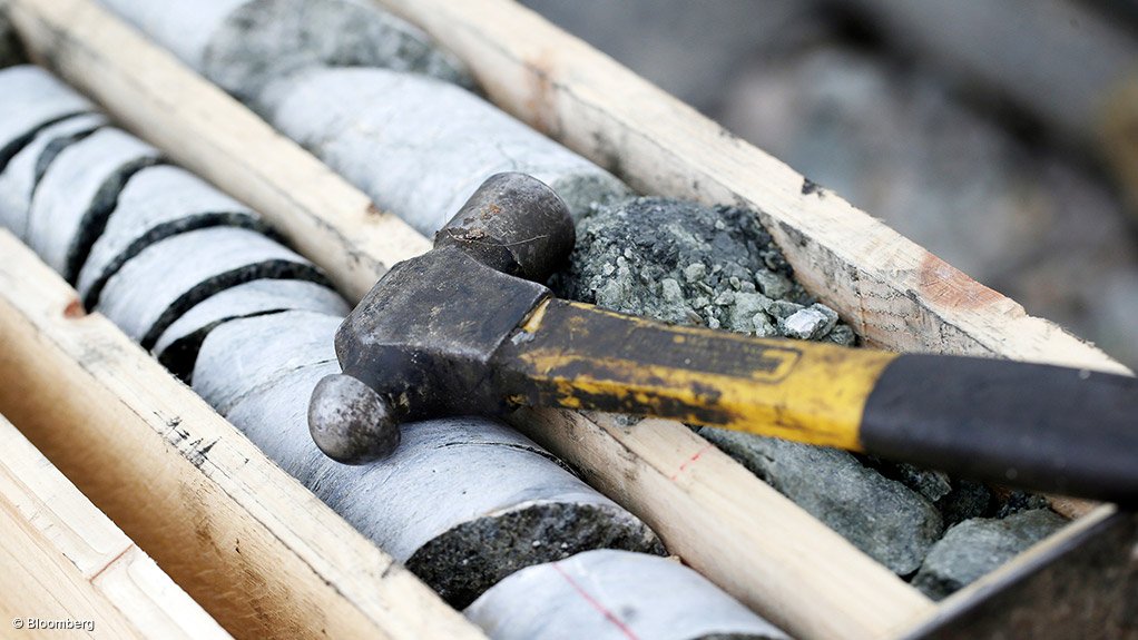 Image shows a core sample and hammer