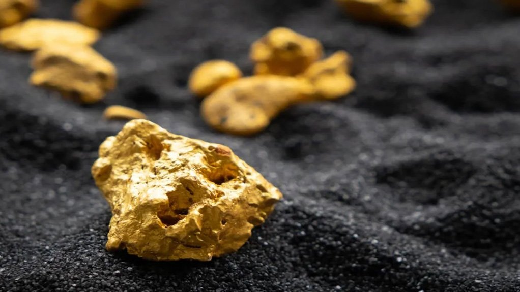gold nuggets placed on a stark black fine sand background as a generic mage for Tresor Gold
