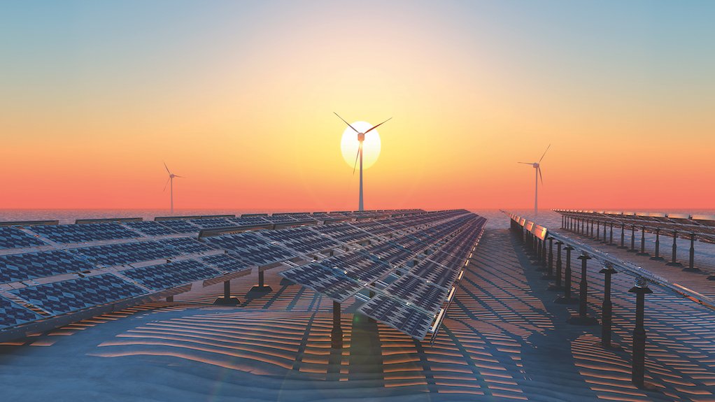 Image of solar panels and wind turbines at sunset