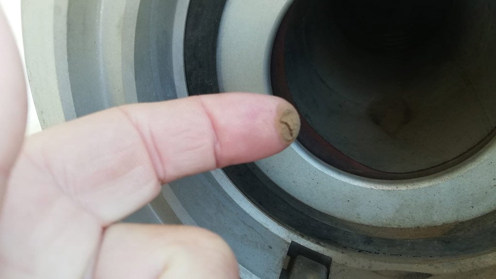 Image of finger showing the amount of dust it picked up in a fuel truck hose