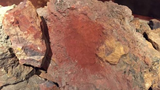 A large red rock which shows clear indications of a high grade iron-ore deposit