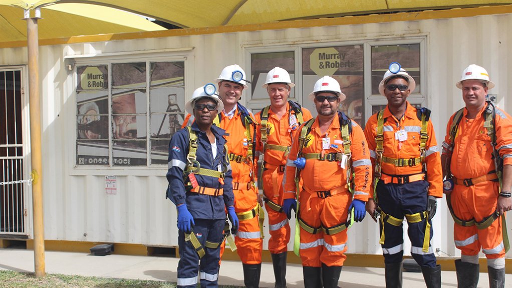 Some of the Murray & Roberts Cementation team celebrating reaching the 1 000 m mark on the ventilation shaft sink at PMC