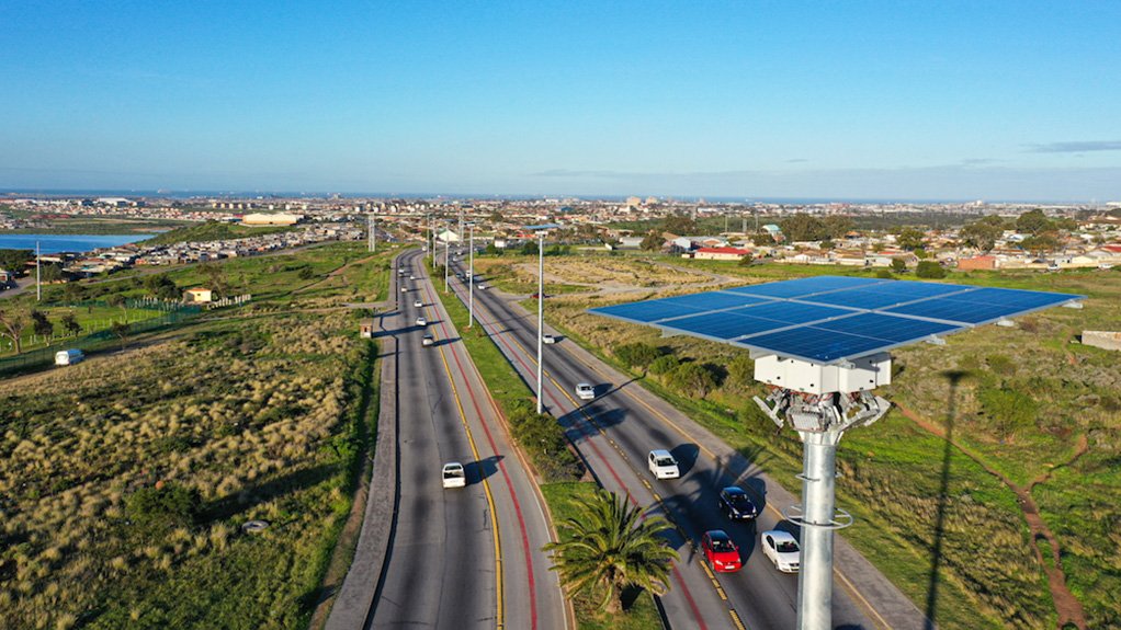 A 20m high streetlight with a solar panel on top installed along Stanford Road in Gqeberha with the area in the background