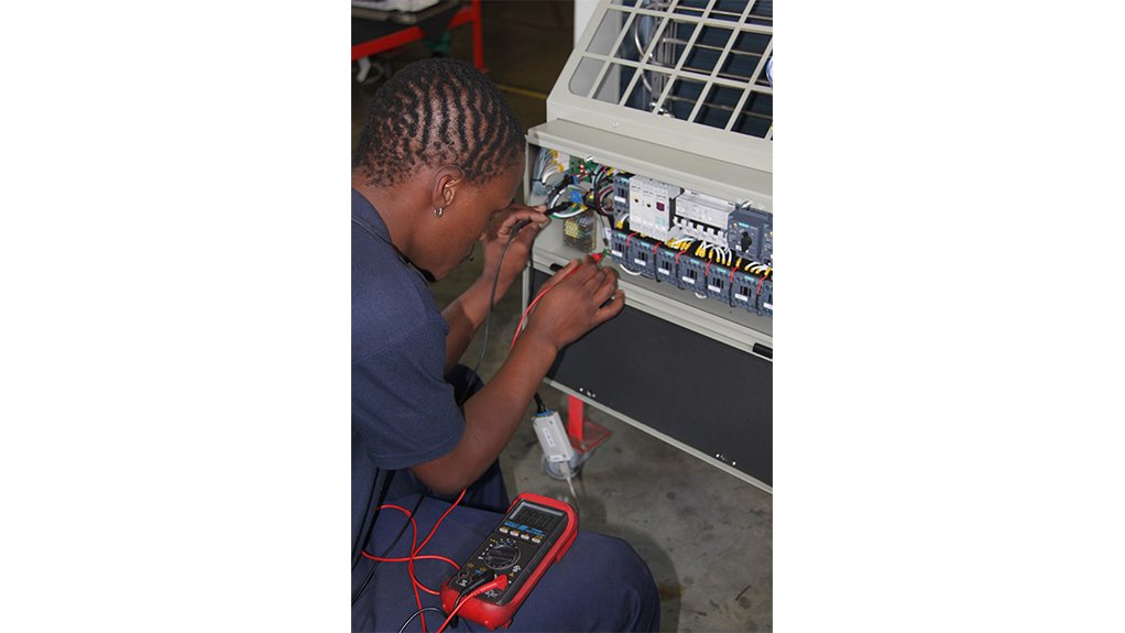  The above image depicts a Booyco Engineering technician working on one of their HVAC units 