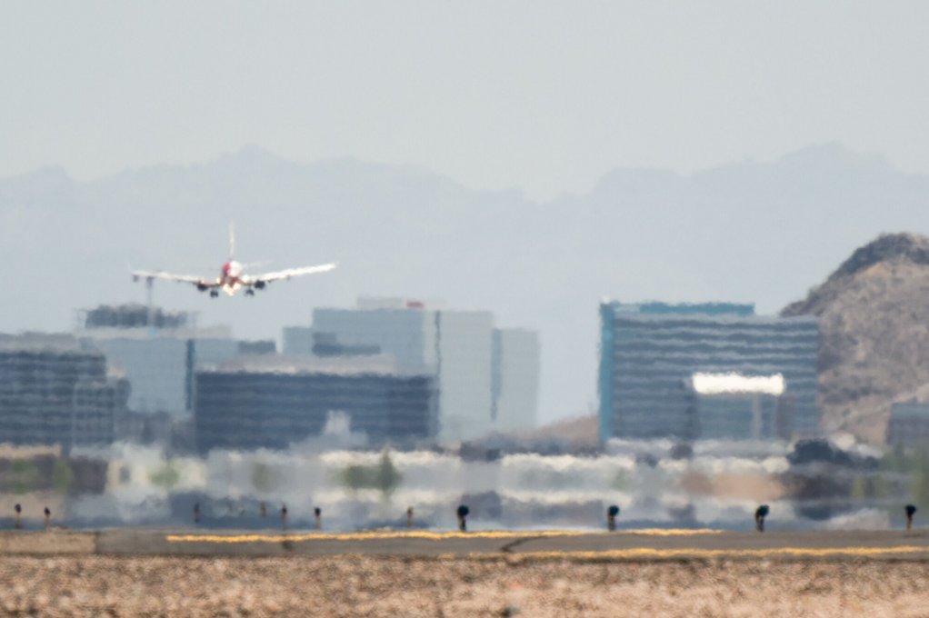 THROUGH THE HAZE: While the aviation industry has promised to achieve net zero carbon emissions by 2050, harsher weather conditions are already forcing a rethink of critical infrastructure in airports, such as this Arizona airport pictured during a recent protracted heat wave. Bloomberg reports that airports around the world are relocating sensitive electrical equipment to rooftops to protect it from flooding, reinforcing runways to handle extreme temperature swings and revving up air conditioning as climate change complicates operations.