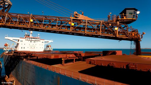 Image shows iron-ore being loaded to ship