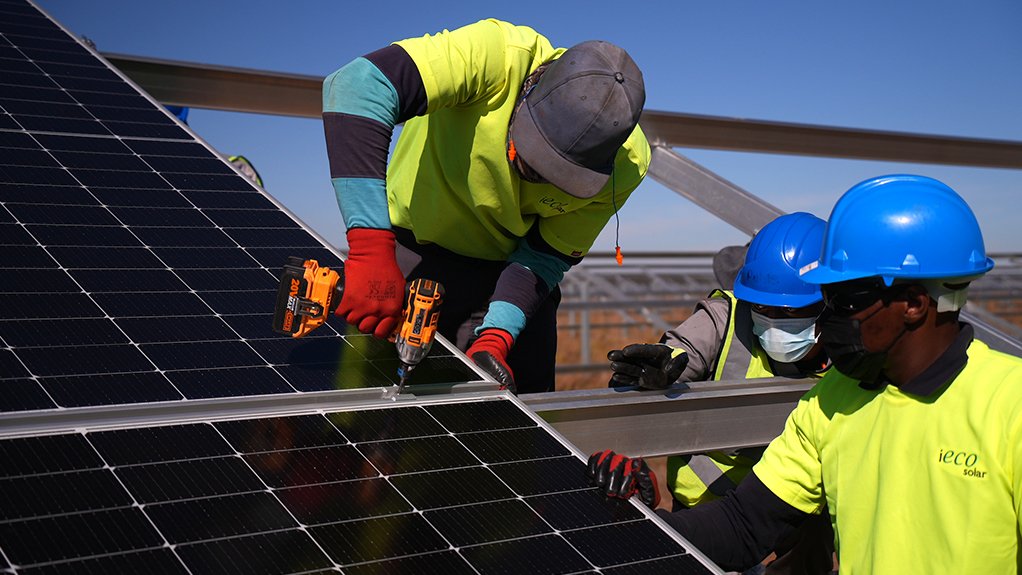 An image of works installing solar panel at the South Deep Khanyisa Solar Plant