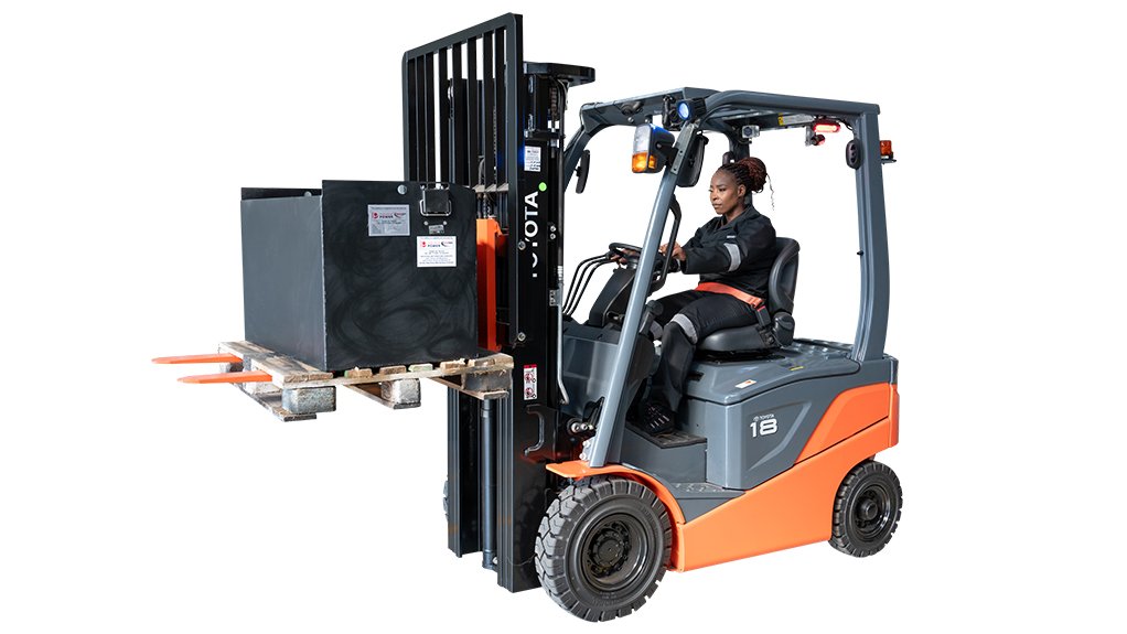A new battery powered Toypta forklift being driven by a woman in PPE