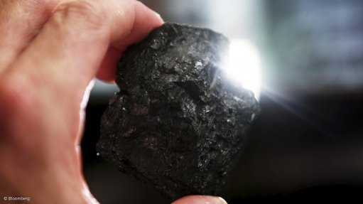 hand holding coal