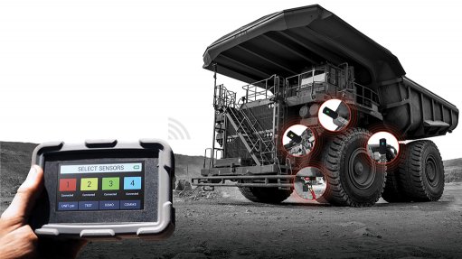 Image of a handheld tablet monitoring a large truck in the background