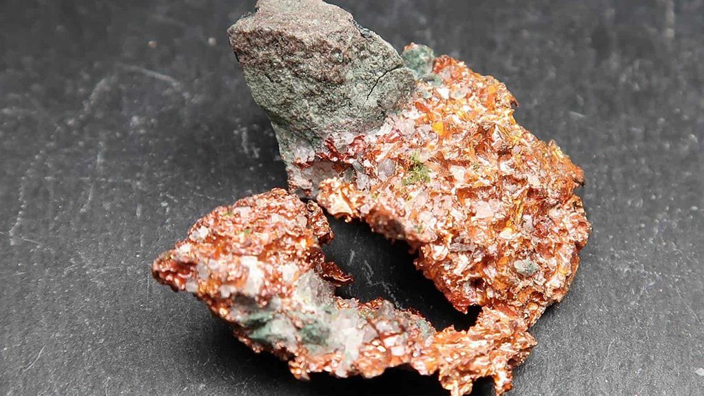 a raw piece of copper ore on a black background