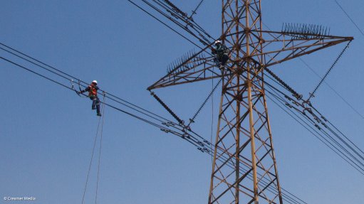 Lineworkers seen working on an Eskom transmission line