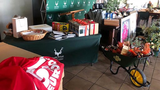 Image of SANParks logos at a table of merchandise to show that SEW-EURODRIVE sponsors SANParks Honorary Rangers Mbombela branch
