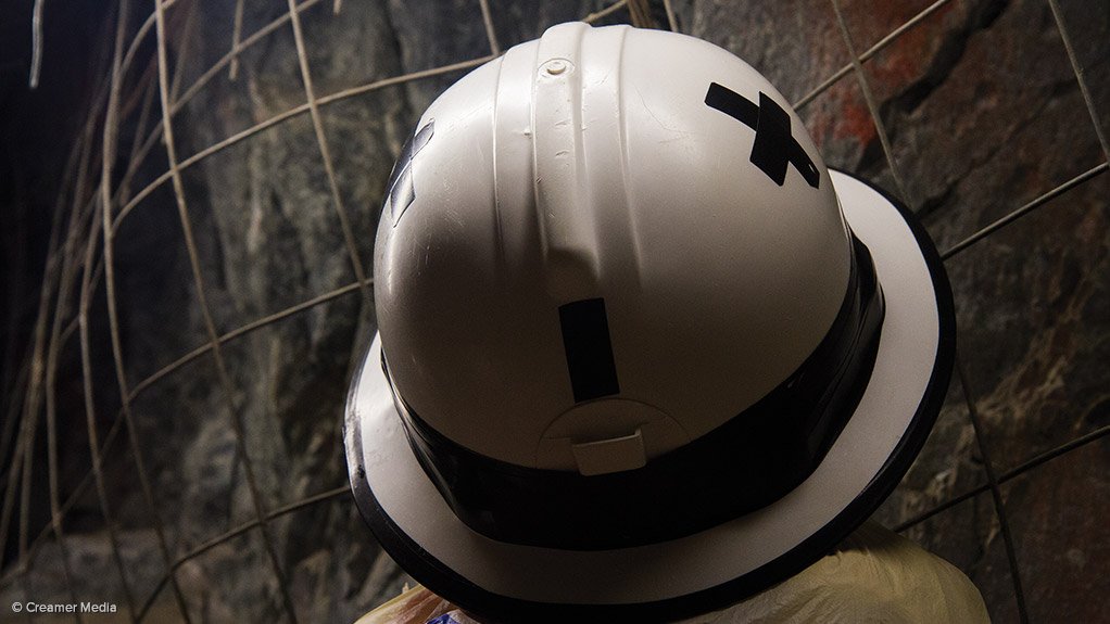 Employee wearing a hard hat in an underground gold mine