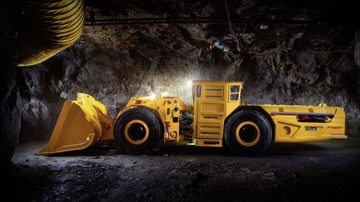 a yellow Komatsu WX07 wheel loader underground in stark lighting