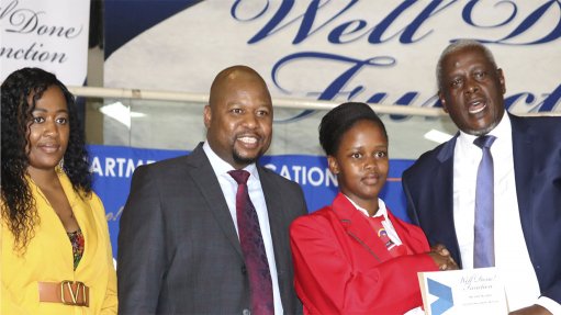 Voorspoed Mine Corporate Affairs Manager, Lebogang Mphaka, Free State MEC of Education, Makalo Mohale and Free State Premier, Mxolisi Dukwana congratulating one of the top learners at the Free State Matric Well-Done function