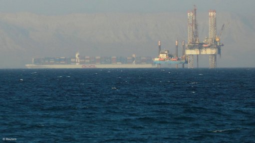 A container ship passing an oil platform near the Suez Canal