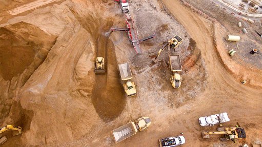 An aerial view of a formal copper mine in DRC with load haul dump vehicles