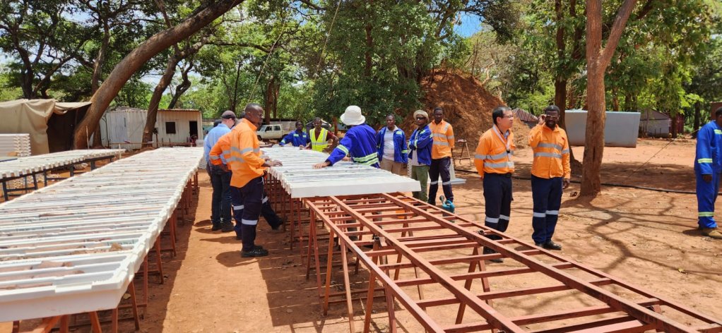 Men at site all wearing PPE at a core sampling table