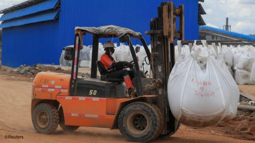 A worker drives a forklift loaded with lithium concentrate at Prospect Lithium Zimbabwe mine in Goromonzi, Zimbabwe