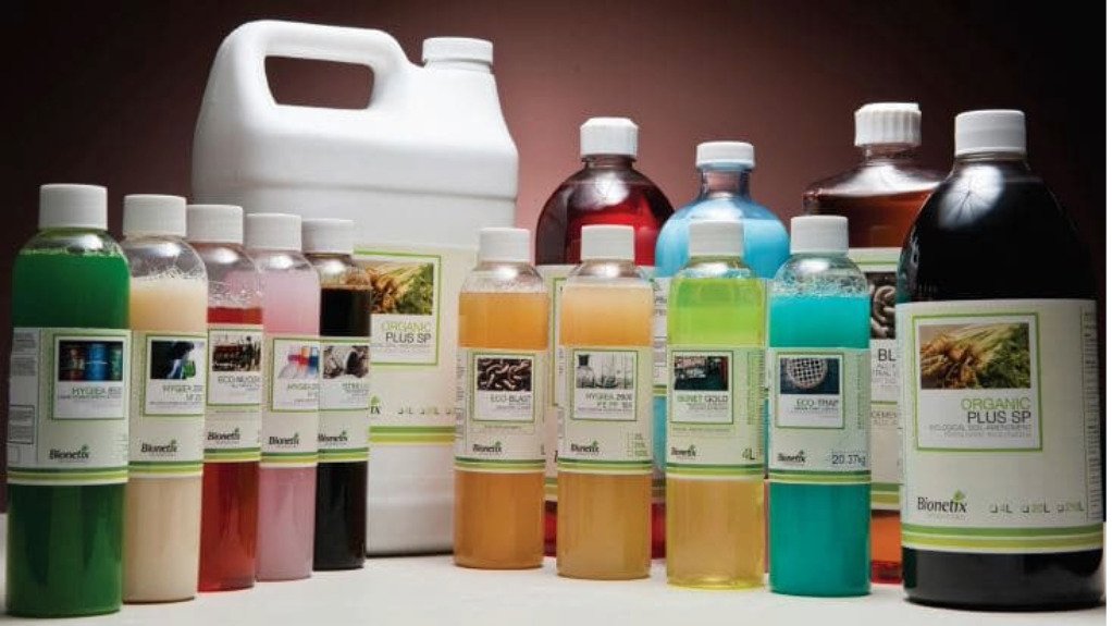 A range of bottles filled with various colour liquids used for cleaning