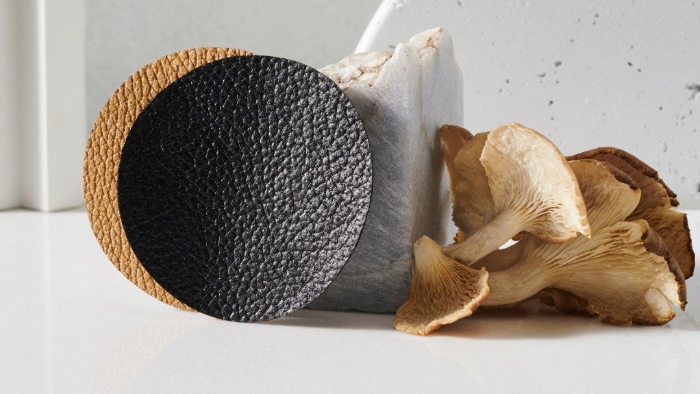 Mushrooms next to two manufactured leather rounds 