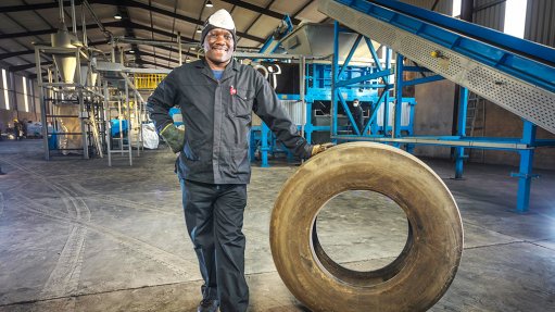 An image showing a factory worker with a tyre at the Mathe Group factory 