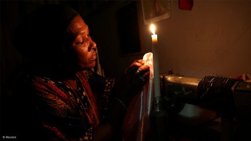 A person using candles during power cuts