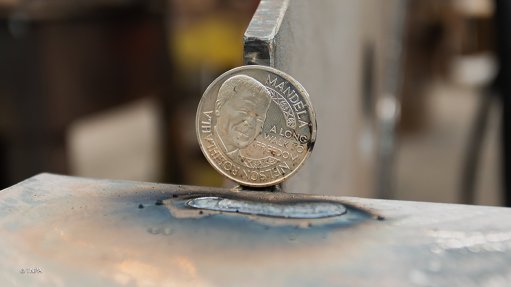 The Mandela Peace Prize coin placed underneath the keel