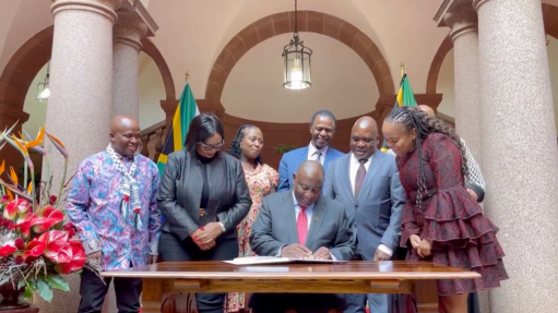 President Cyril Ramaphosa signing the controversial NHI Bill into law at a Union Buildings ceremony