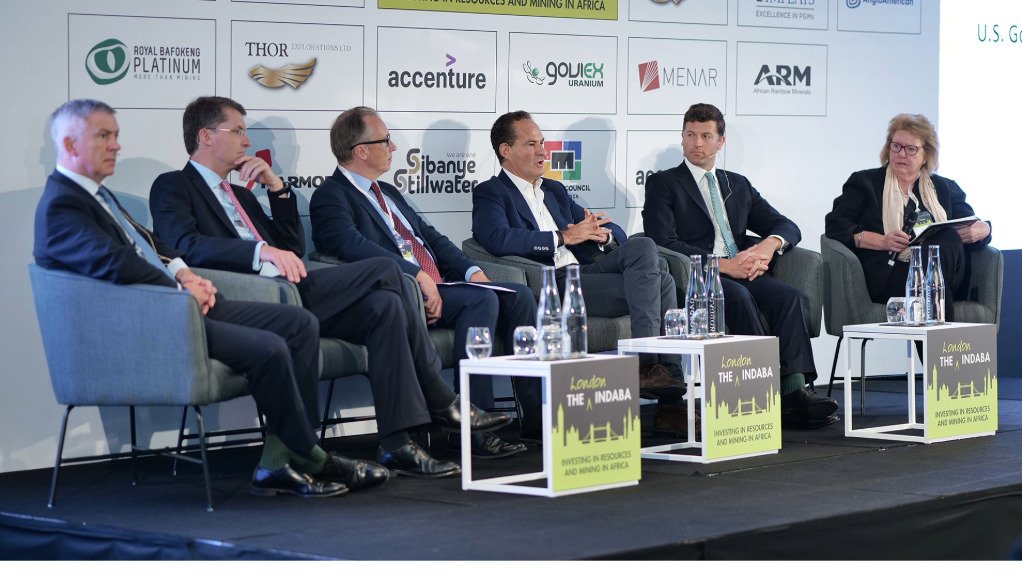 Men and women sitting on a stage in a panel discussion at the 2023 London indaba